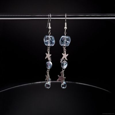 Long stainless steel starfish dangle earrings with light blue glass beads and crystal drops. Beach themed silver ocean jewelry with fishhook wires, featuring sea star charms and faceted aqua crystals for women