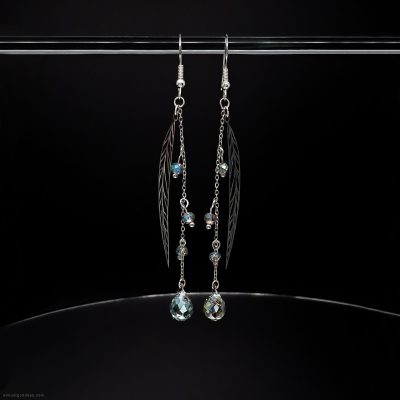 Long stainless steel dangle earrings with silver leaf charms and green crystal beads. Bohemian chain drop earrings featuring faceted teardrop pendants on fishhook wires for sensitive ears