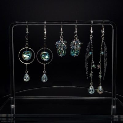 Set of 3 green dangle earrings with stainless steel hooks and faceted glass beads. Bohemian drop earrings collection featuring circle frames, leaf charms, and beaded clusters in emerald and lime green tones for sensitive ears