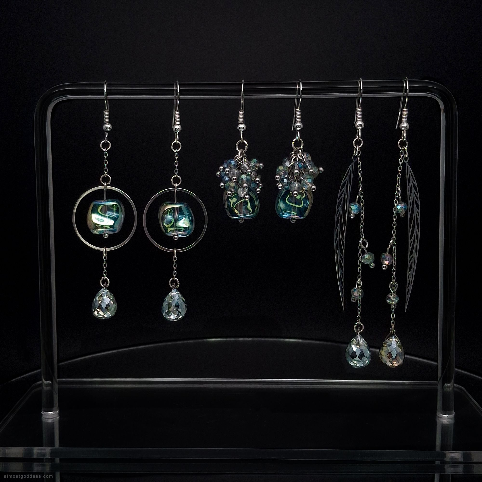 Set of 3 green dangle earrings with stainless steel hooks and faceted glass beads. Bohemian drop earrings collection featuring circle frames, leaf charms, and beaded clusters in emerald and lime green tones for sensitive ears