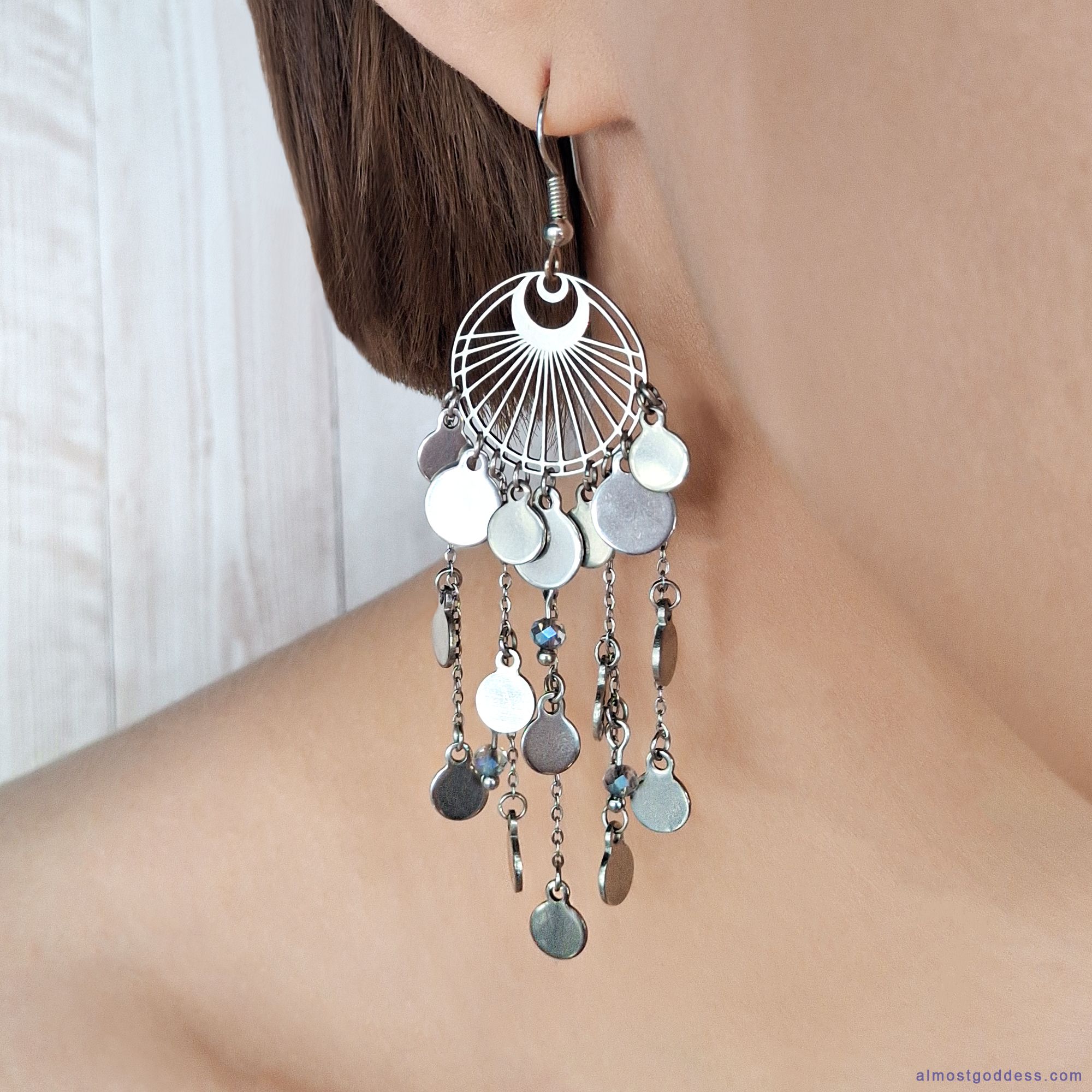 Woman wearing long boho chandelier earrings with silver coin charms and chains - statement dangle earrings for women everyday wear
